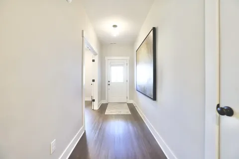 a view of a hallway with wooden floor