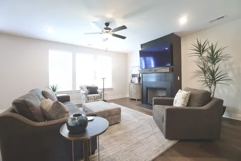 a living room with furniture and a fireplace