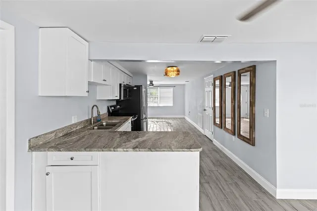 a view of kitchen with sink microwave and stove