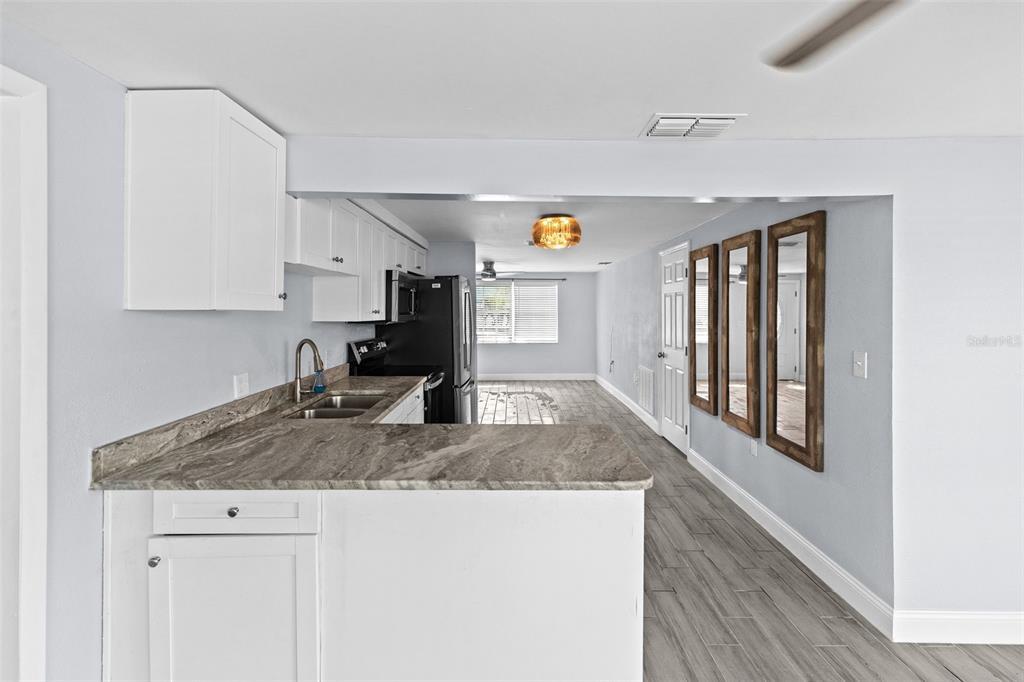 13916 Sommers Avenue Hudson, FL 34667 - Photo 12 of 46 a kitchen with granite countertop a sink and cabinets