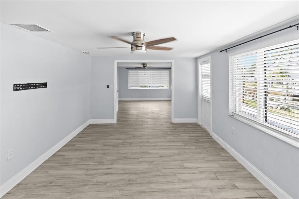 13916 Sommers Avenue Hudson, FL 34667 - Photo 14 of 46 a view of empty room with wooden floor and fan