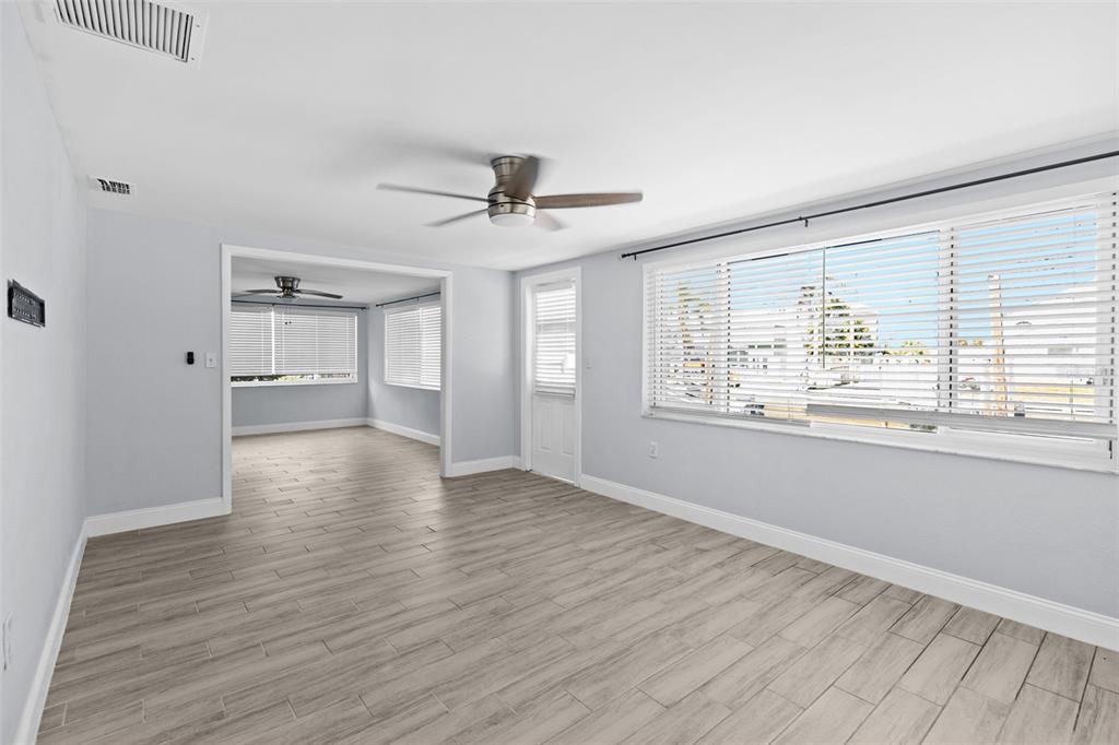 13916 Sommers Avenue Hudson, FL 34667 - Photo 15 of 46 a view of an empty room with a window and wooden floor