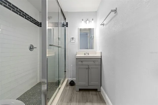 a bathroom with a shower a toilet and a sink