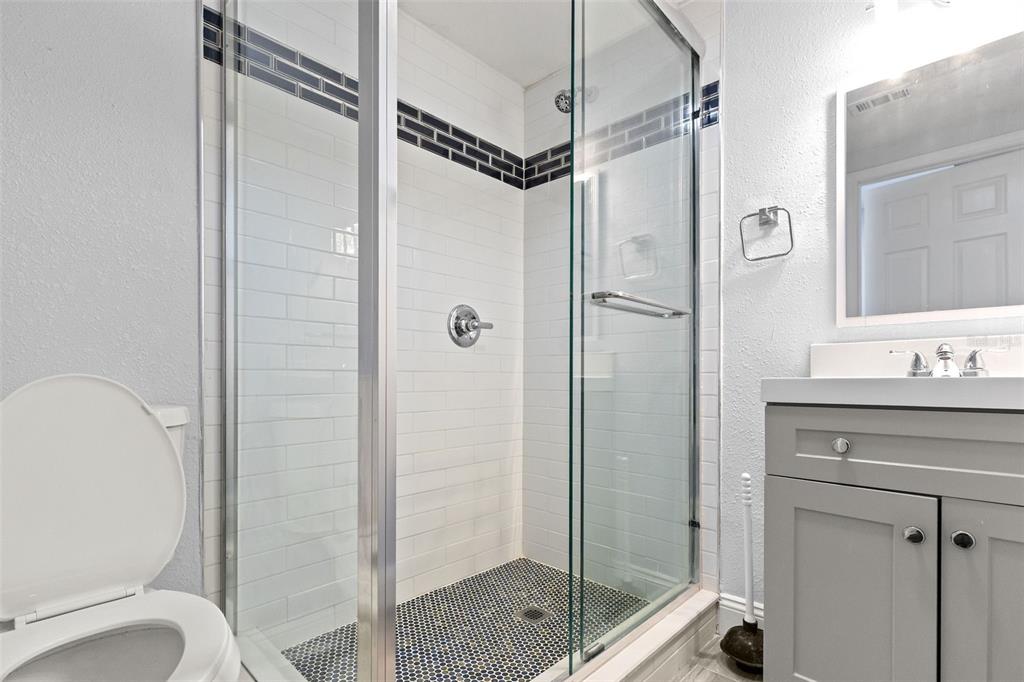 13916 Sommers Avenue Hudson, FL 34667 - Photo 21 of 46 a bathroom with a shower a toilet and a sink