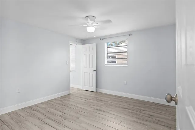 wooden floor in an empty room with a window