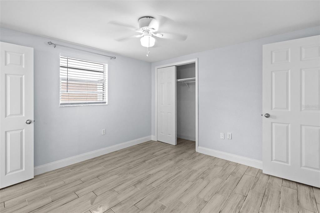 13916 Sommers Avenue Hudson, FL 34667 - Photo 25 of 46 a view of an empty room with a window and wooden floor
