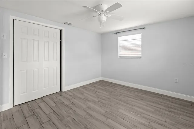 a view of a room with wooden floor and window