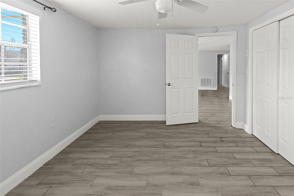 13916 Sommers Avenue Hudson, FL 34667 - Photo 28 of 46 a view of a room with wooden floor and window