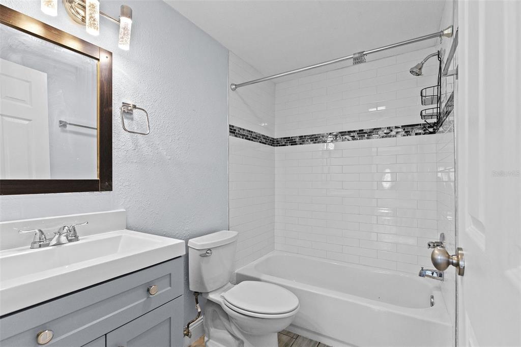 13916 Sommers Avenue Hudson, FL 34667 - Photo 29 of 46 a bathroom with a granite countertop sink toilet and shower