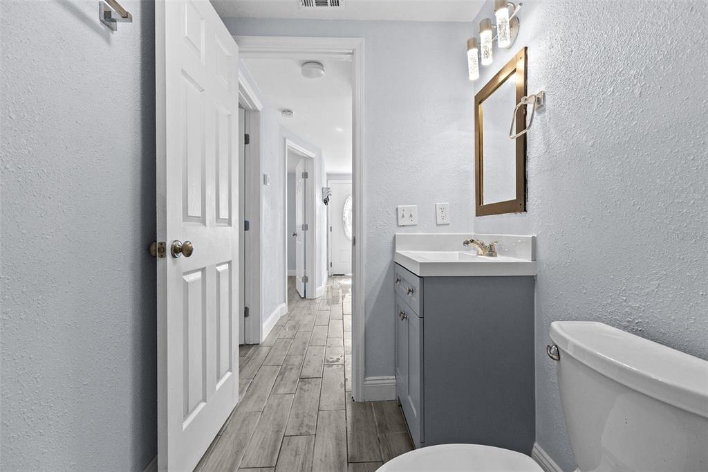 13916 Sommers Avenue Hudson, FL 34667 - Photo 30 of 46 a bathroom with a sink a toilet a mirror and shower