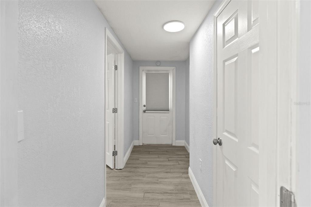 13916 Sommers Avenue Hudson, FL 34667 - Photo 31 of 46 a view of a hallway with wooden floor and staircase