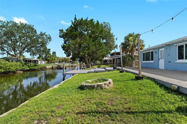 a view of a house with backyard and porch