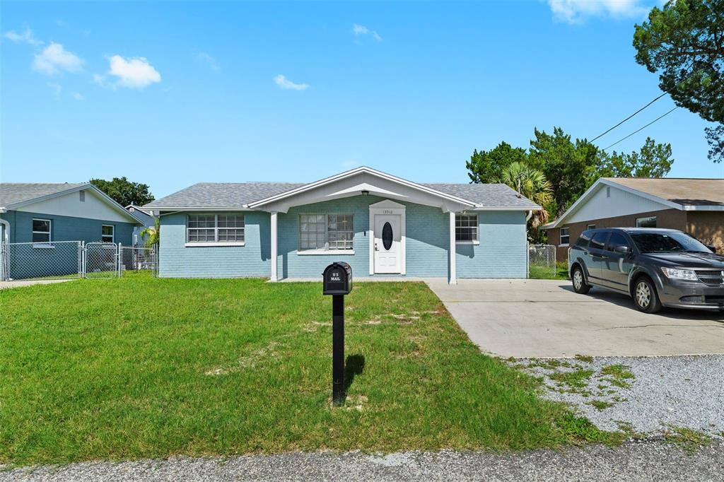13916 Sommers Avenue Hudson, FL 34667 - Photo 46 of 46 a front view of a house with a garden