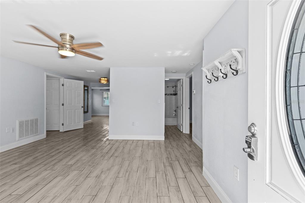 13916 Sommers Avenue Hudson, FL 34667 - Photo 5 of 46 wooden floor in an empty room with a window