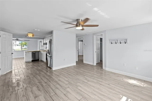 wooden floor in an empty room with a window