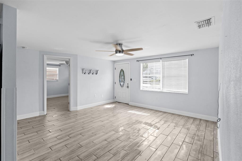 13916 Sommers Avenue Hudson, FL 34667 - Photo 7 of 46 wooden floor in an empty room with a window