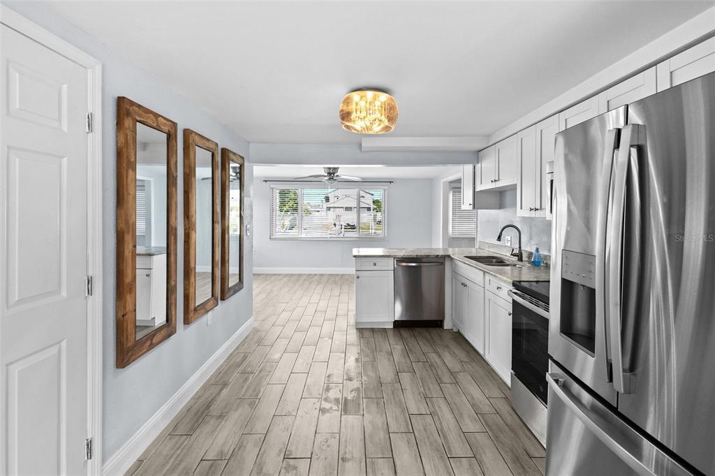 13916 Sommers Avenue Hudson, FL 34667 - Photo 8 of 46 a kitchen with a refrigerator a sink and a stove top oven