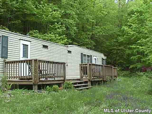 148 Rudy Frank Rd Extension Shandaken, NY 12480 - Photo 1 of 10 a front view of a house with a garden