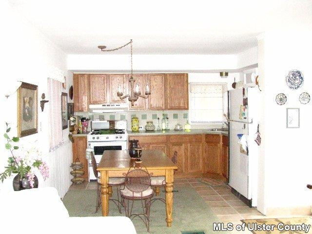 148 Rudy Frank Rd Extension Shandaken, NY 12480 - Photo 3 of 10 a kitchen with stainless steel appliances kitchen island granite countertop a refrigerator and a stove