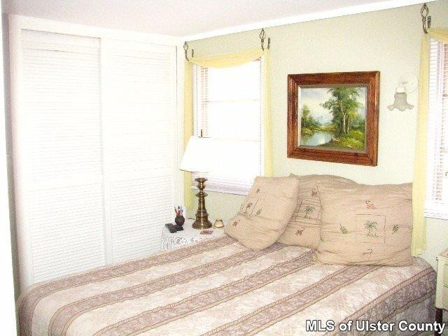 148 Rudy Frank Rd Extension Shandaken, NY 12480 - Photo 5 of 10 a bed room with a bed and a painting on the wall