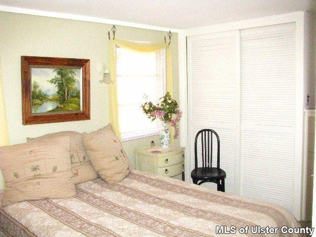 148 Rudy Frank Rd Extension Shandaken, NY 12480 - Photo 6 of 10 a bedroom with a bed and a large window