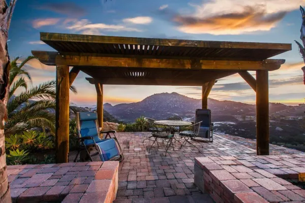 a view of a patio with a table chairs and a fire pit