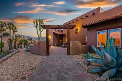 a view of a porch with furniture and floor to ceiling window