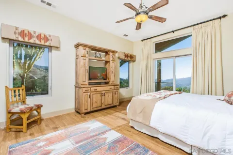 a bedroom with a bed and a flat screen tv