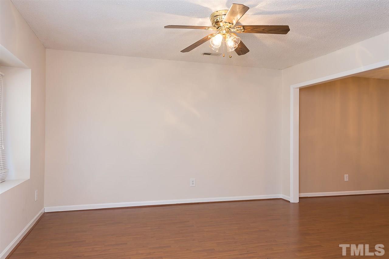7606 Ladden Court Raleigh, NC 27615 - Photo 2 of 16 an empty room with a window and a fan