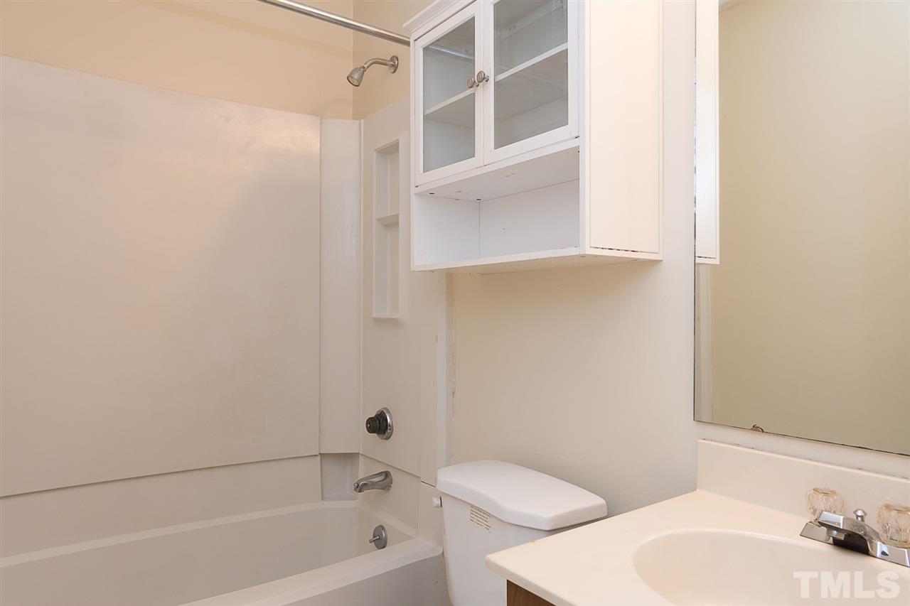 7606 Ladden Court Raleigh, NC 27615 - Photo 11 of 16 a bathroom with a sink and a bathtub