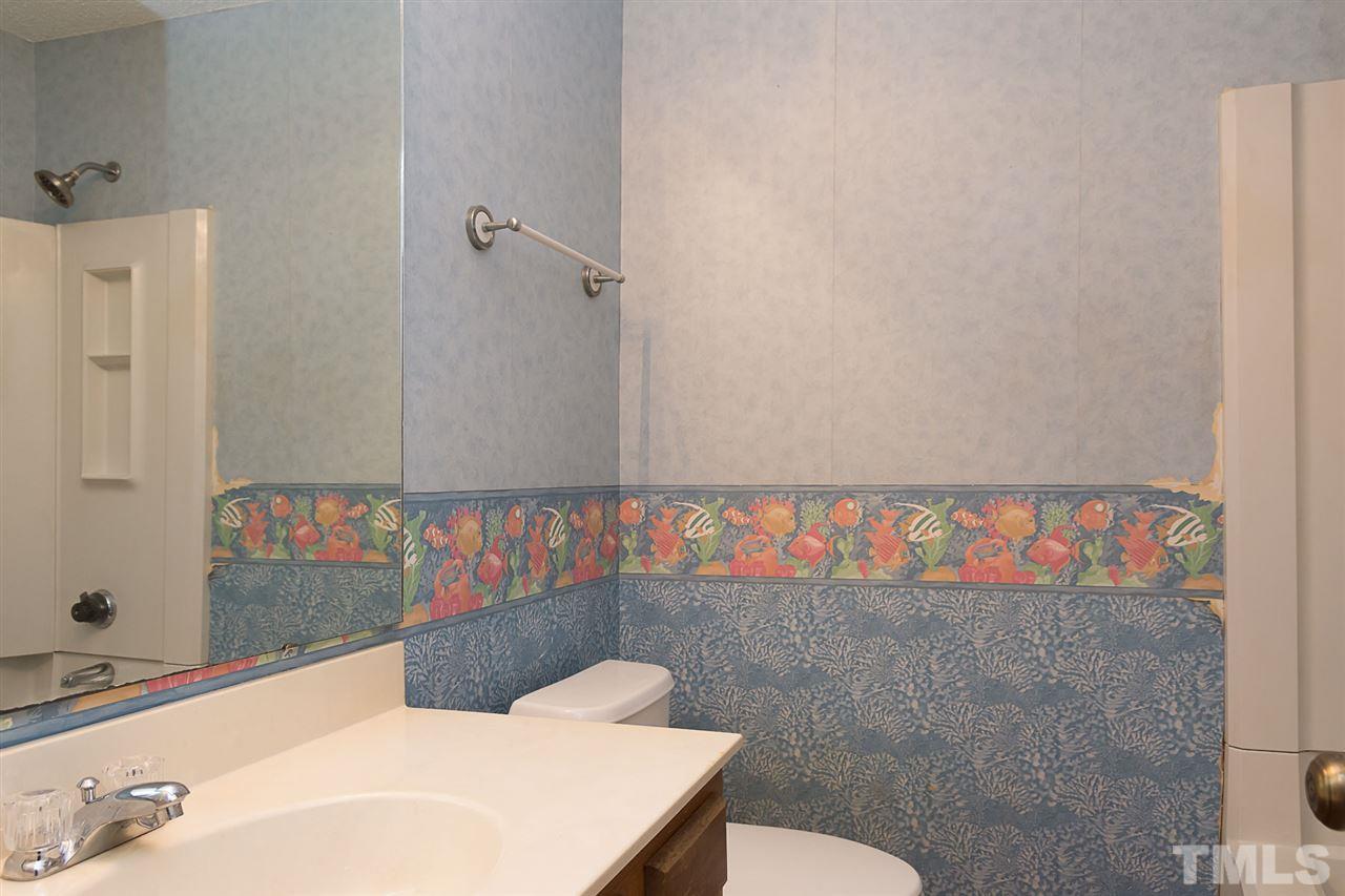7606 Ladden Court Raleigh, NC 27615 - Photo 12 of 16 a bathroom with a sink and a mirror