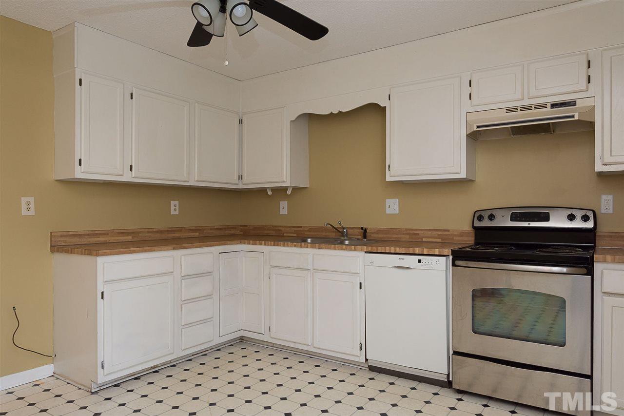 7606 Ladden Court Raleigh, NC 27615 - Photo 7 of 16 a kitchen with granite countertop cabinets stainless steel appliances and a sink
