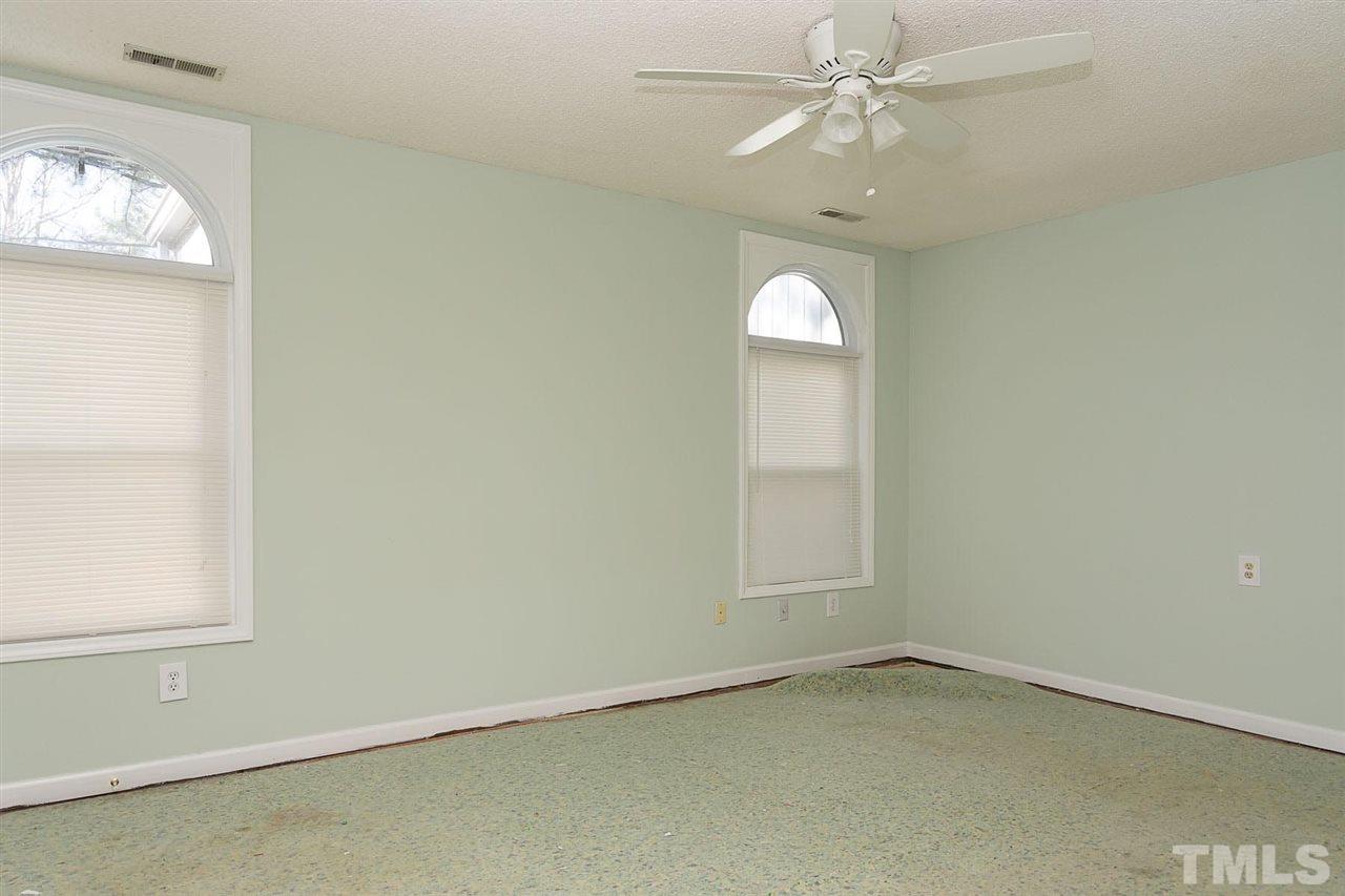 7606 Ladden Court Raleigh, NC 27615 - Photo 9 of 16 an empty room with windows and fan