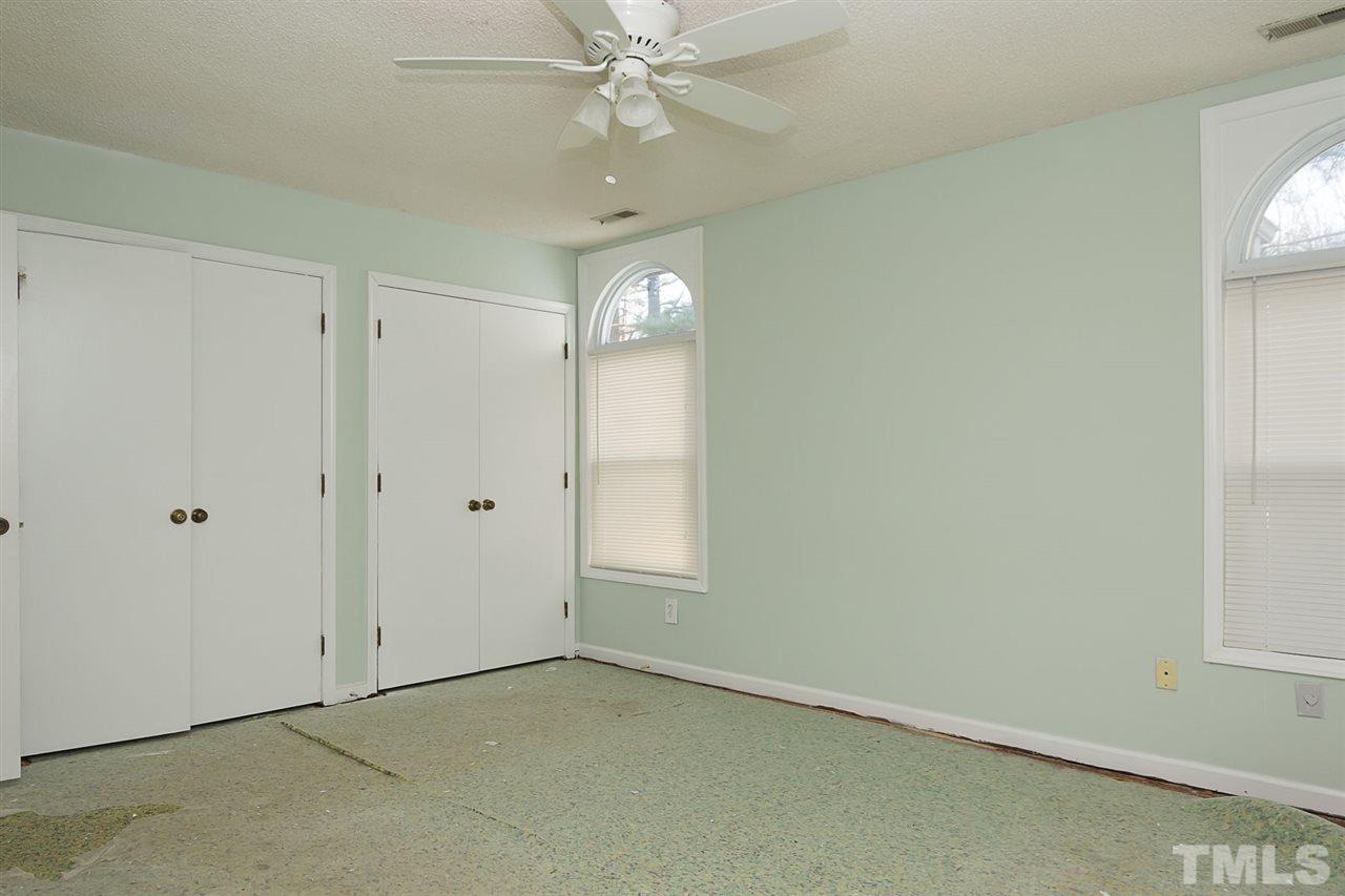 7606 Ladden Court Raleigh, NC 27615 - Photo 10 of 16 an empty room with chandelier fan and windows