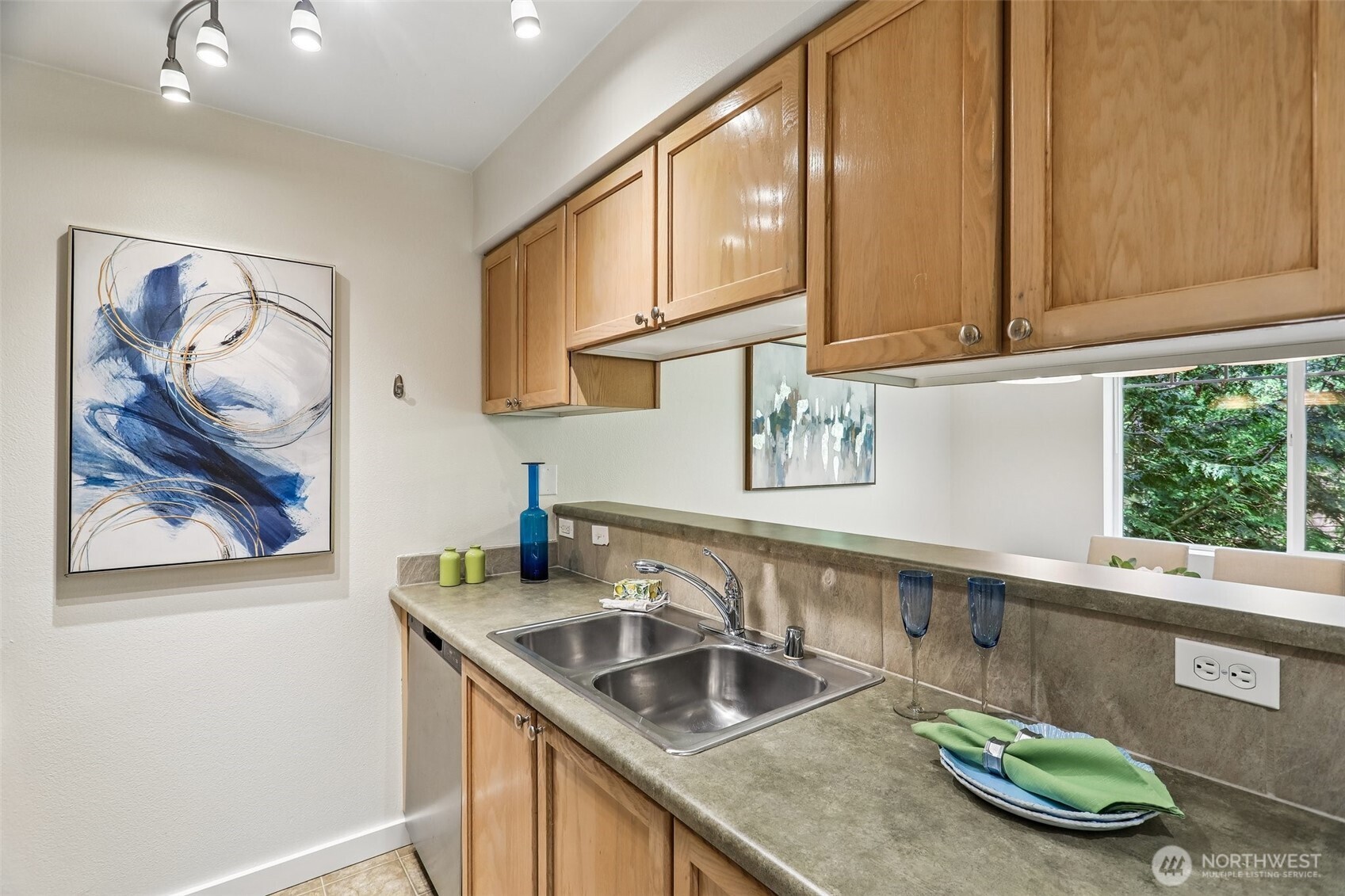 18930 Bothell Everett Highway, Unit E301 Bothell, WA 98012 - Photo 10 of 28 a kitchen with stainless steel appliances granite countertop a sink and a microwave