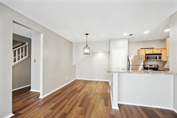 a kitchen with a refrigerator and a stove top oven