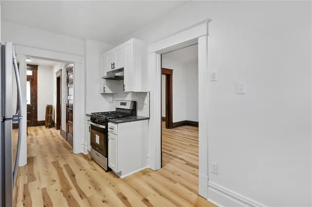 a kitchen with wooden floor and a stove