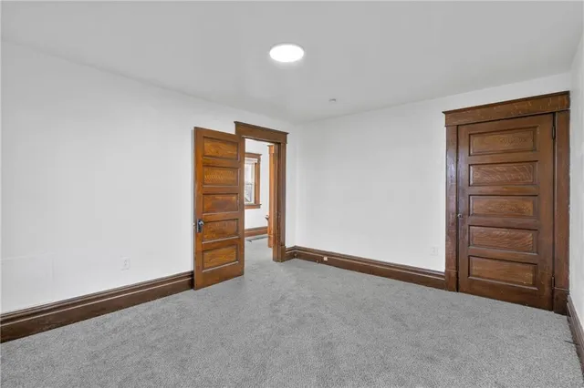 a view of an empty room and fire place