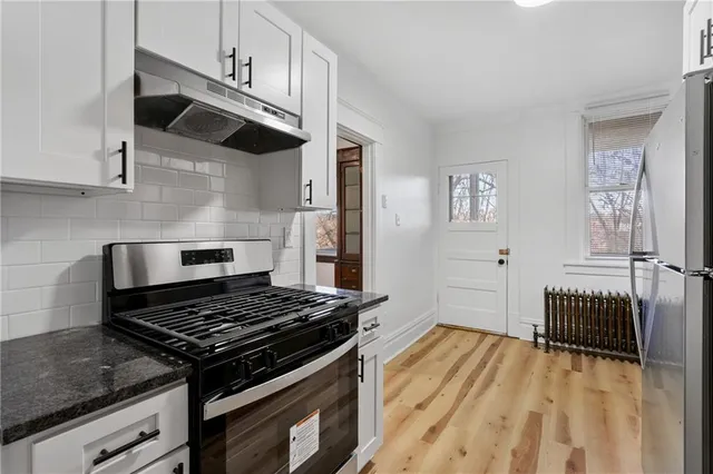 a kitchen with wooden cabinets and a stove top oven