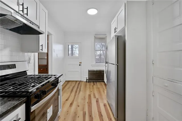 a kitchen with granite countertop a stove and a refrigerator