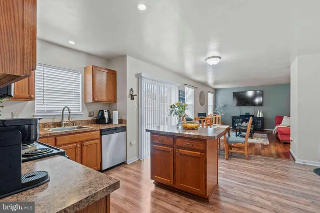 a kitchen with stainless steel appliances granite countertop a stove and cabinets