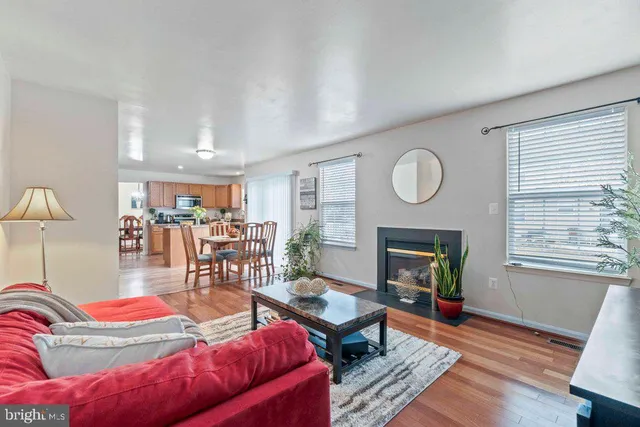 a living room with furniture a fireplace and a window