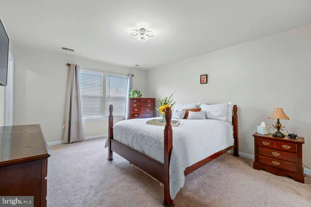 a bedroom with a bed and a dresser