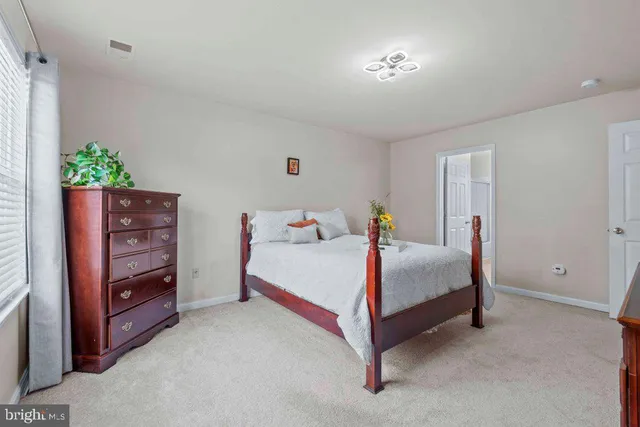 a room with a bed and a dresser