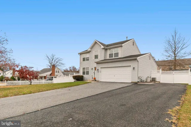 a view of a house with a yard and garage