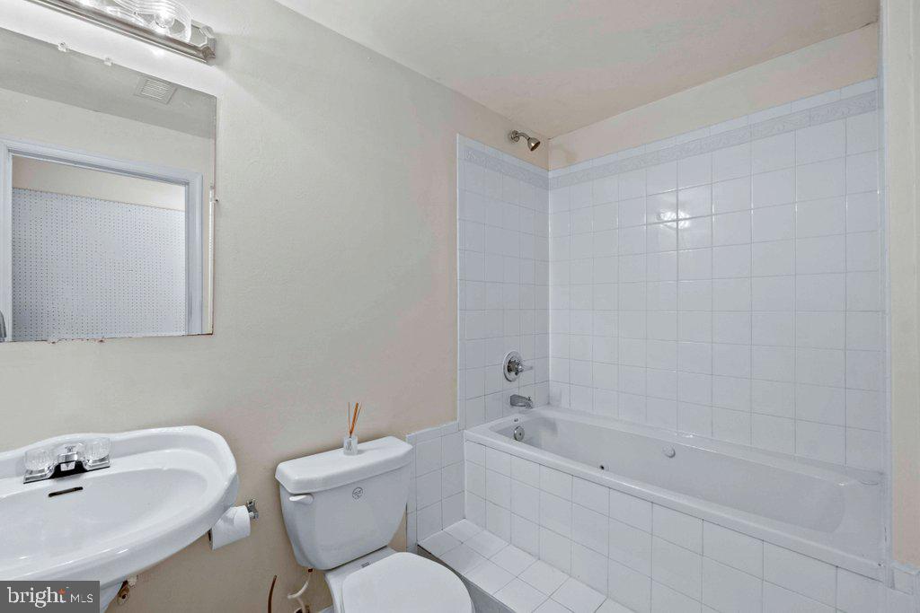 4305 Silver Spring Road Perry Hall, MD 21236 - Photo 39 of 48 a bathroom with a sink mirror toilet and bathtub