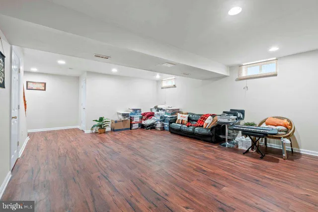 a view of a room with furniture and wooden floor