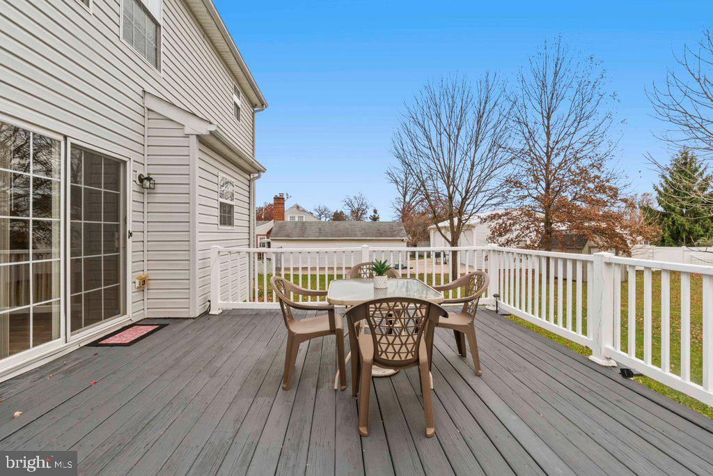 4305 Silver Spring Road Perry Hall, MD 21236 - Photo 43 of 48 a view of a deck with table and chairs and wooden floor