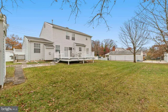 a house view with swimming pool in front of it