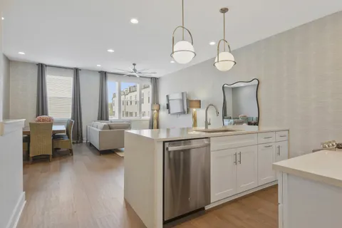 a very nice looking room with kitchen island a large island in the center
